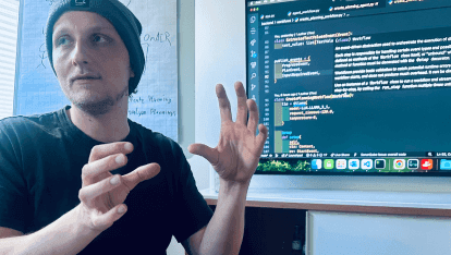 Entwickler präsentiert ein Projekt auf einem Bildschirm.